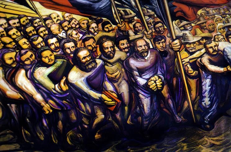 En el mural Del Porfirismo a la Revolución, Ricardo Flores Magón y los líderes del Partido Liberal Mexicano fueron plasmados por David Alfaro Siqueiros, al lado de los teóricos del comunismo y el anarquismo. Por ello, se ve a Karl Marx, Federico Engels y, a Bakunin y Proudhon, en marcha incesante hacia la liberación. Foto recuperada de: ¡Tierra y Libertad! El sueño de una Revolución.
